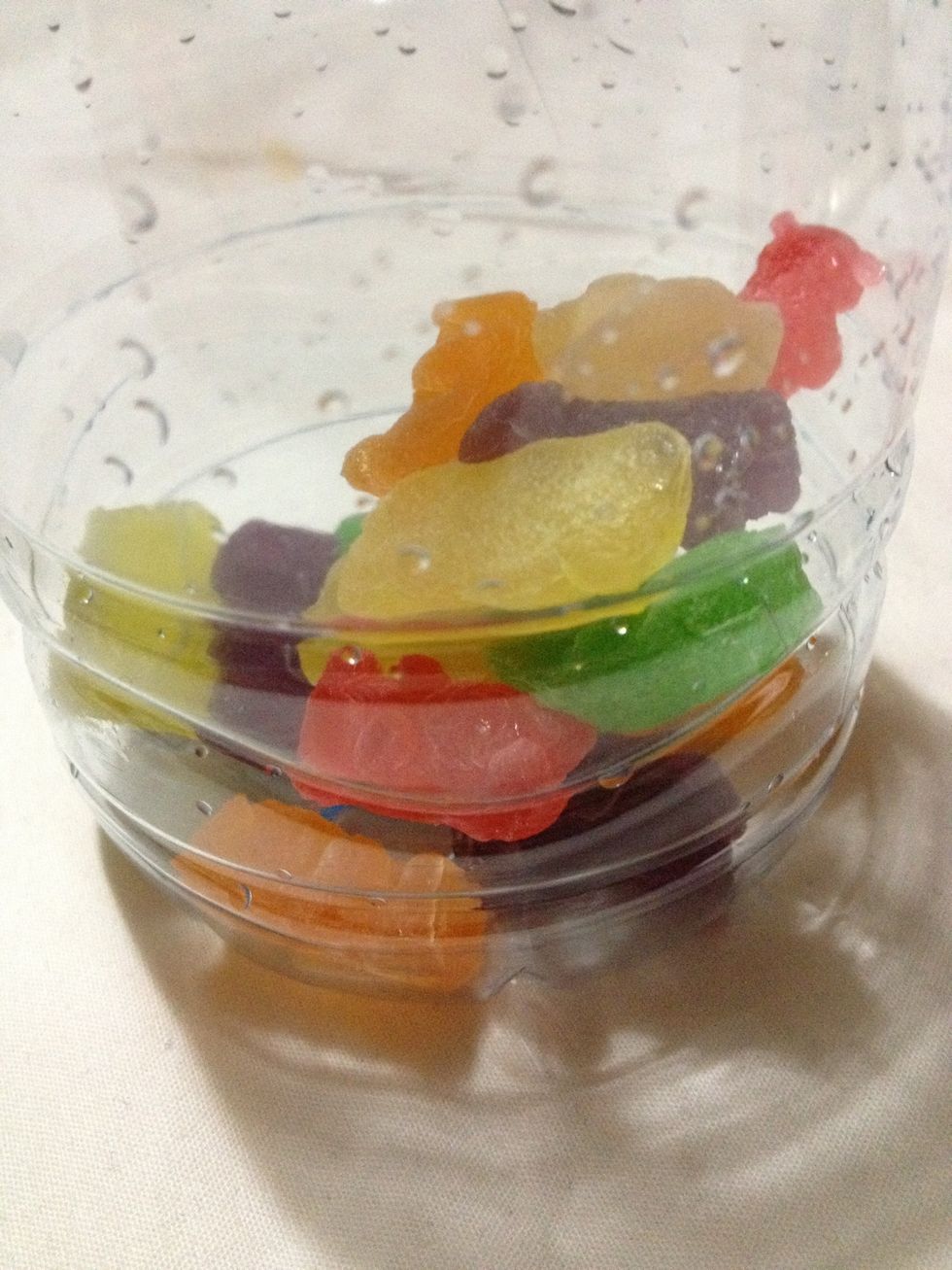 Put the jelly bears inside the container.
