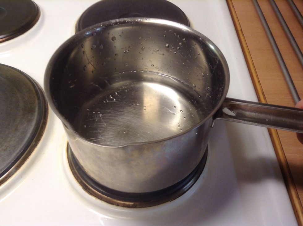 Put the kettle onto the hob and heat the water.