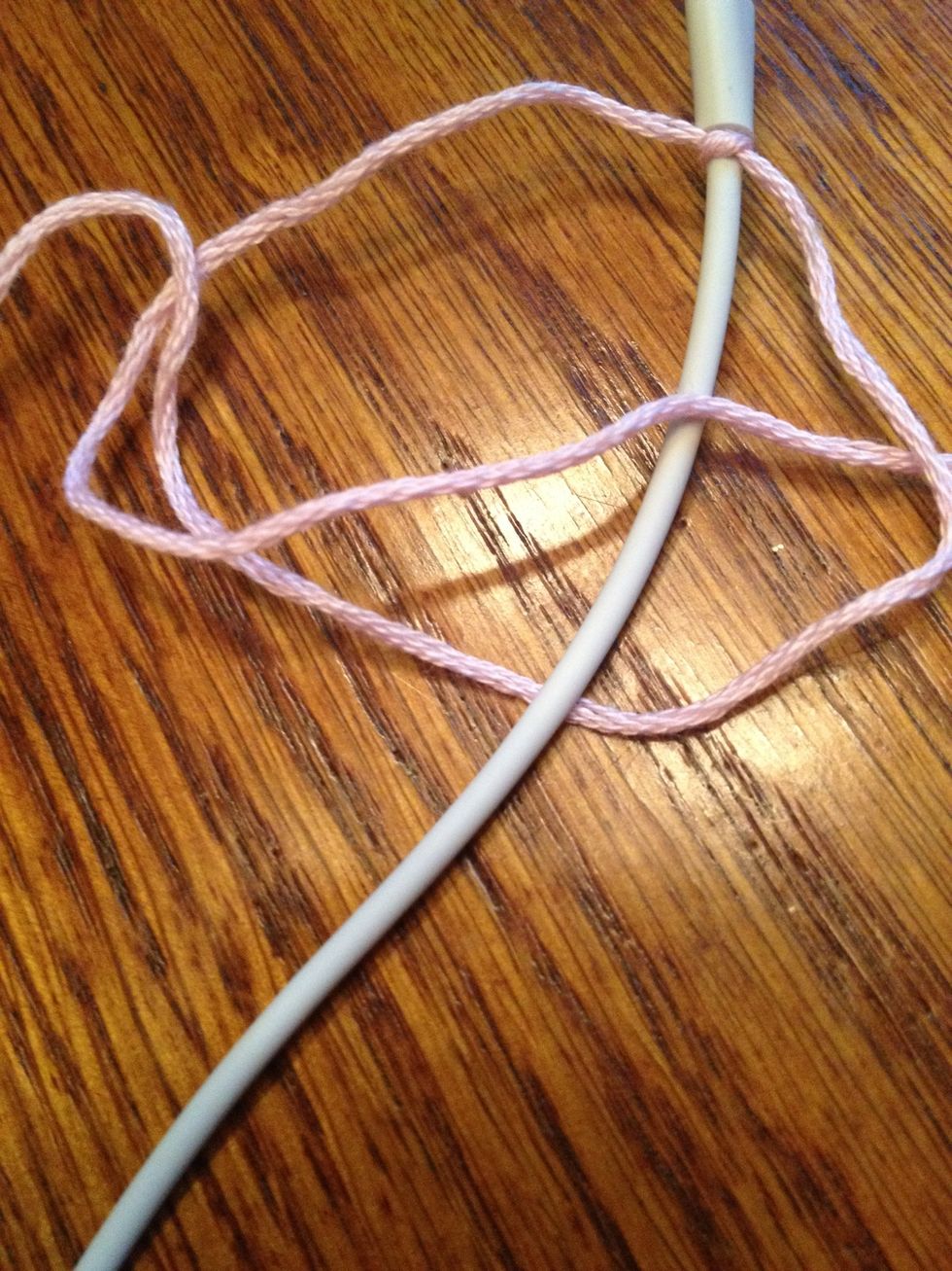 Put the left string over the cord and through the right hole