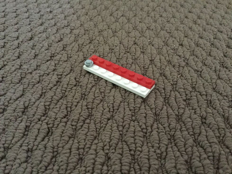 Put the long red piece and small silver piece together like this.