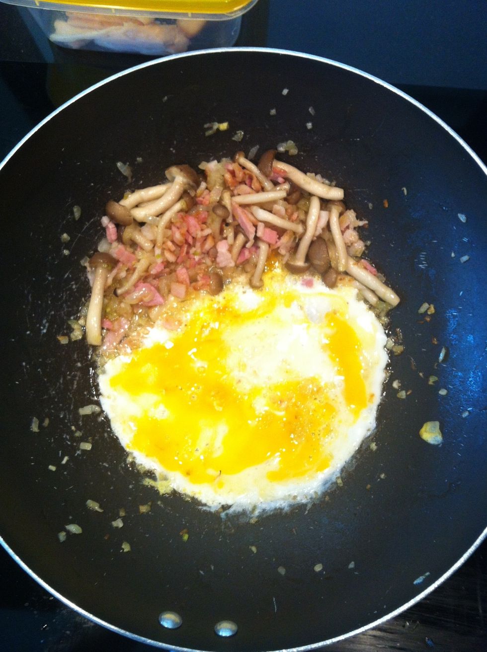 Put the lot on the side of the pan and crack an egg