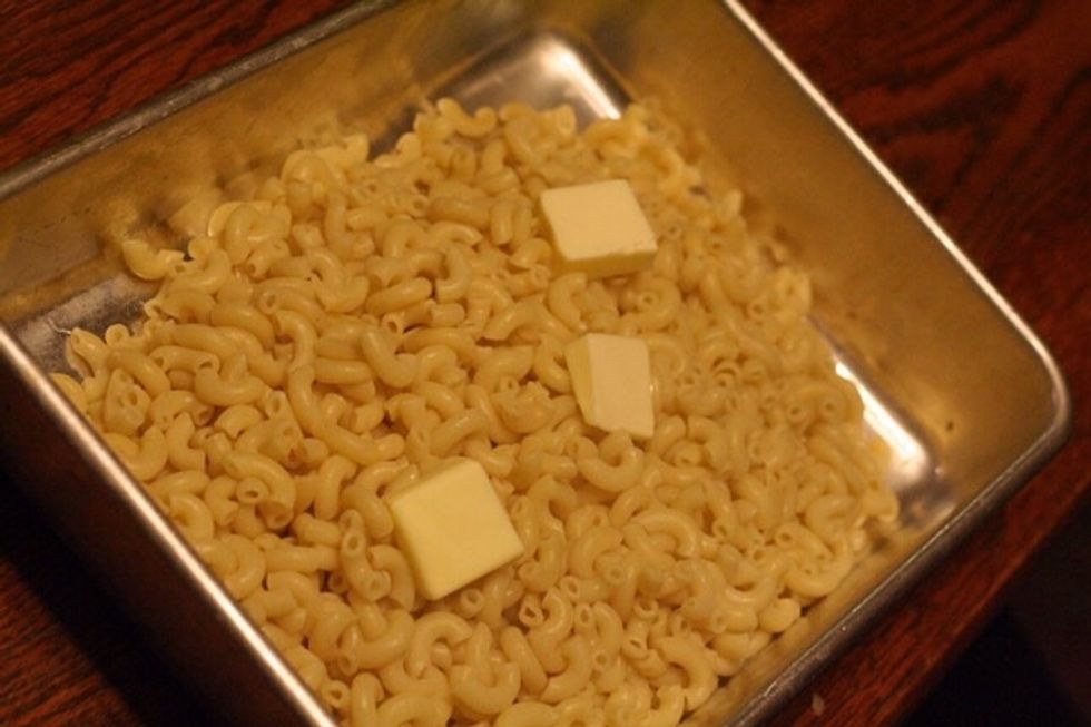 Put the Macaroni in a pan and but 1/4 cup of butter on it.
