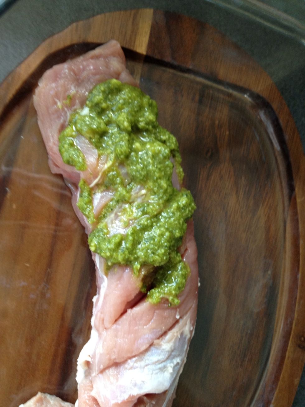 Put the meat into the dish and start filling the pockets with pesto.  Don't put the spoon that touches the meat into the pesto, use two spoons, one for the pesto and one to fill in the pockets.