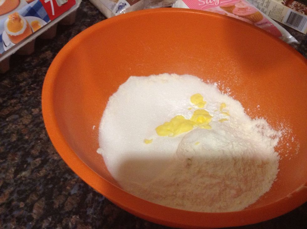 Put the melted butter in the mixing bowl.
