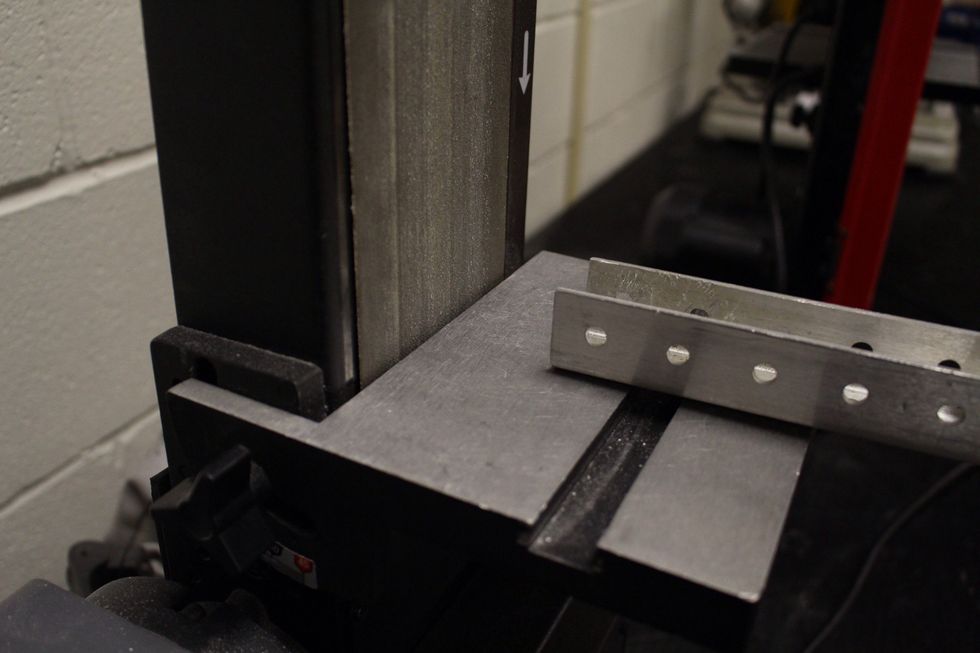 Put the metal on the metal plate of the sander