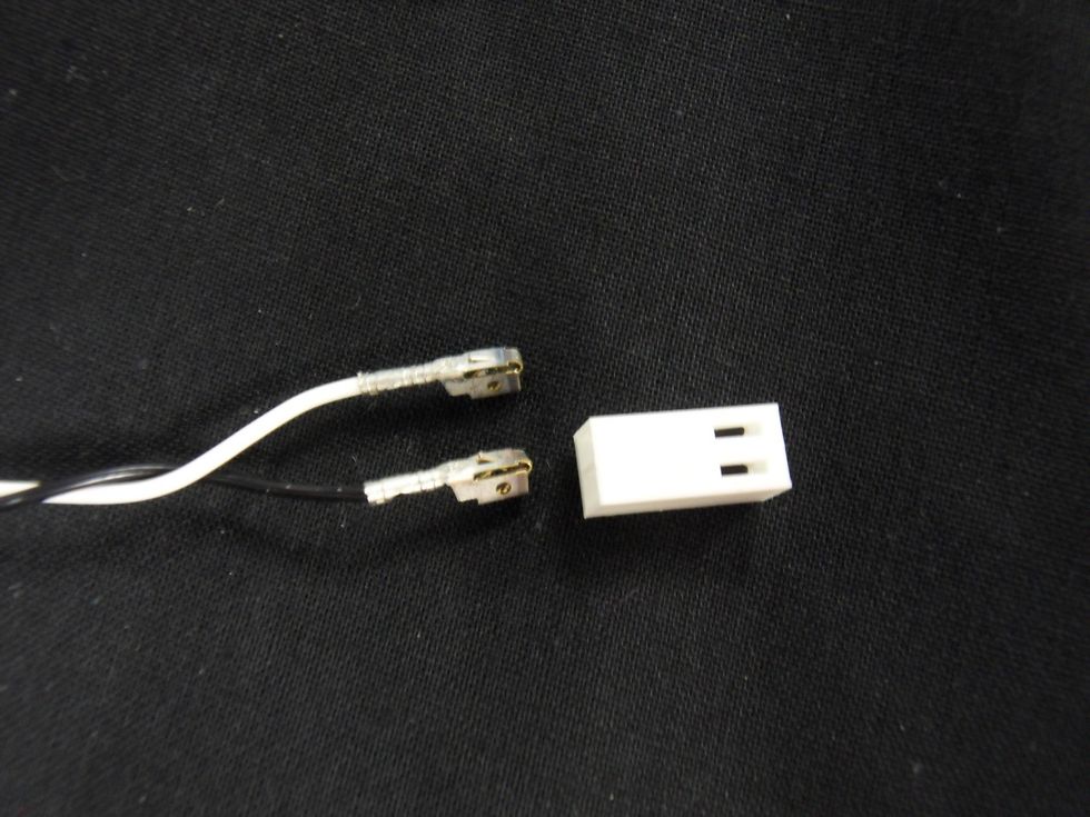 Put the metal sockets into the housing such that the tabs line up with the holes and click into place.