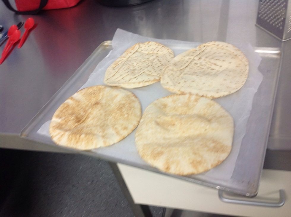 Put the mini pizza bases on the baking tray