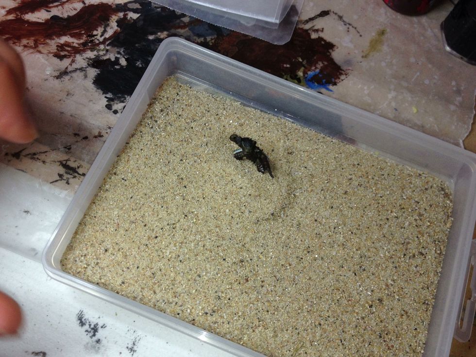 Put the miniature's base into a box of Citadel Sand.