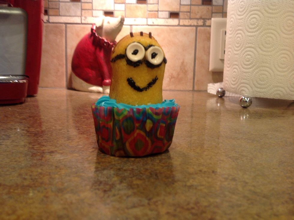 Put the minion on the cupcake