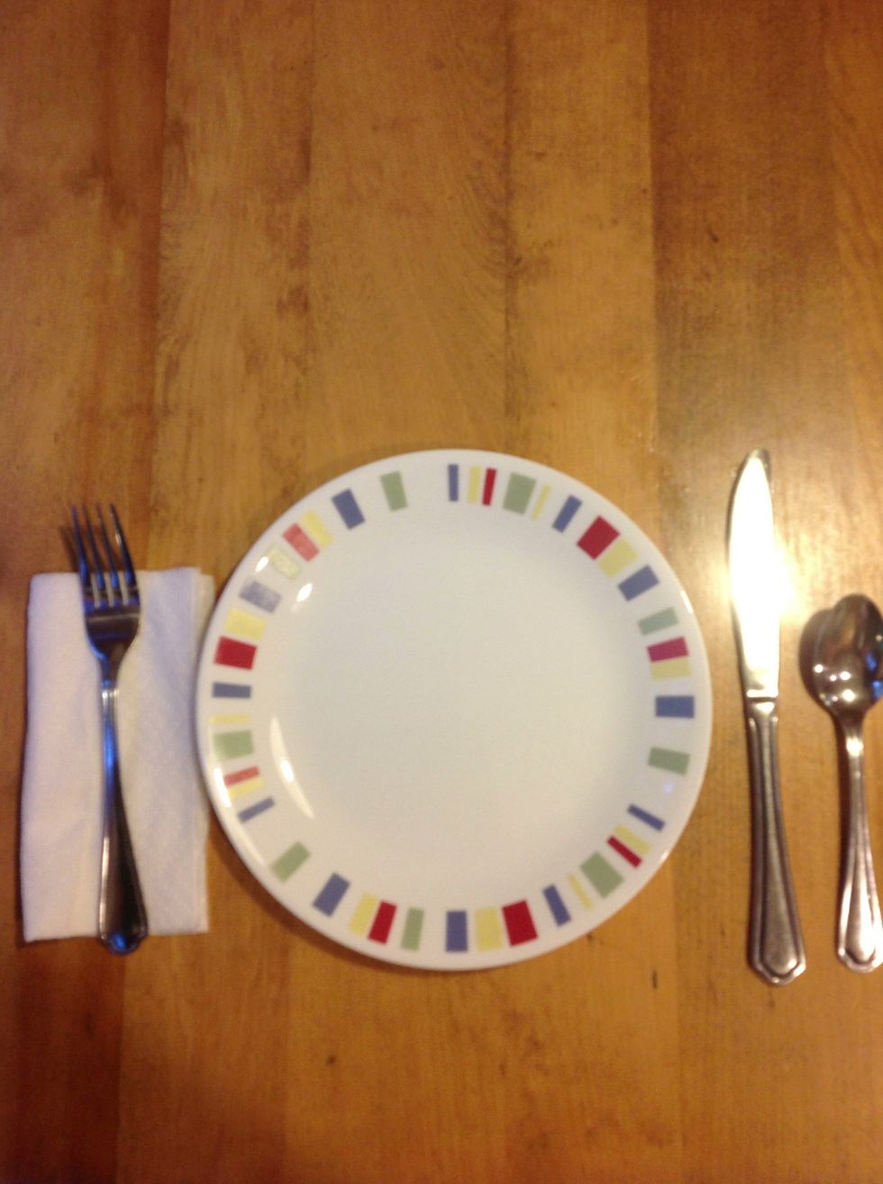 Put the napkin under the fork.