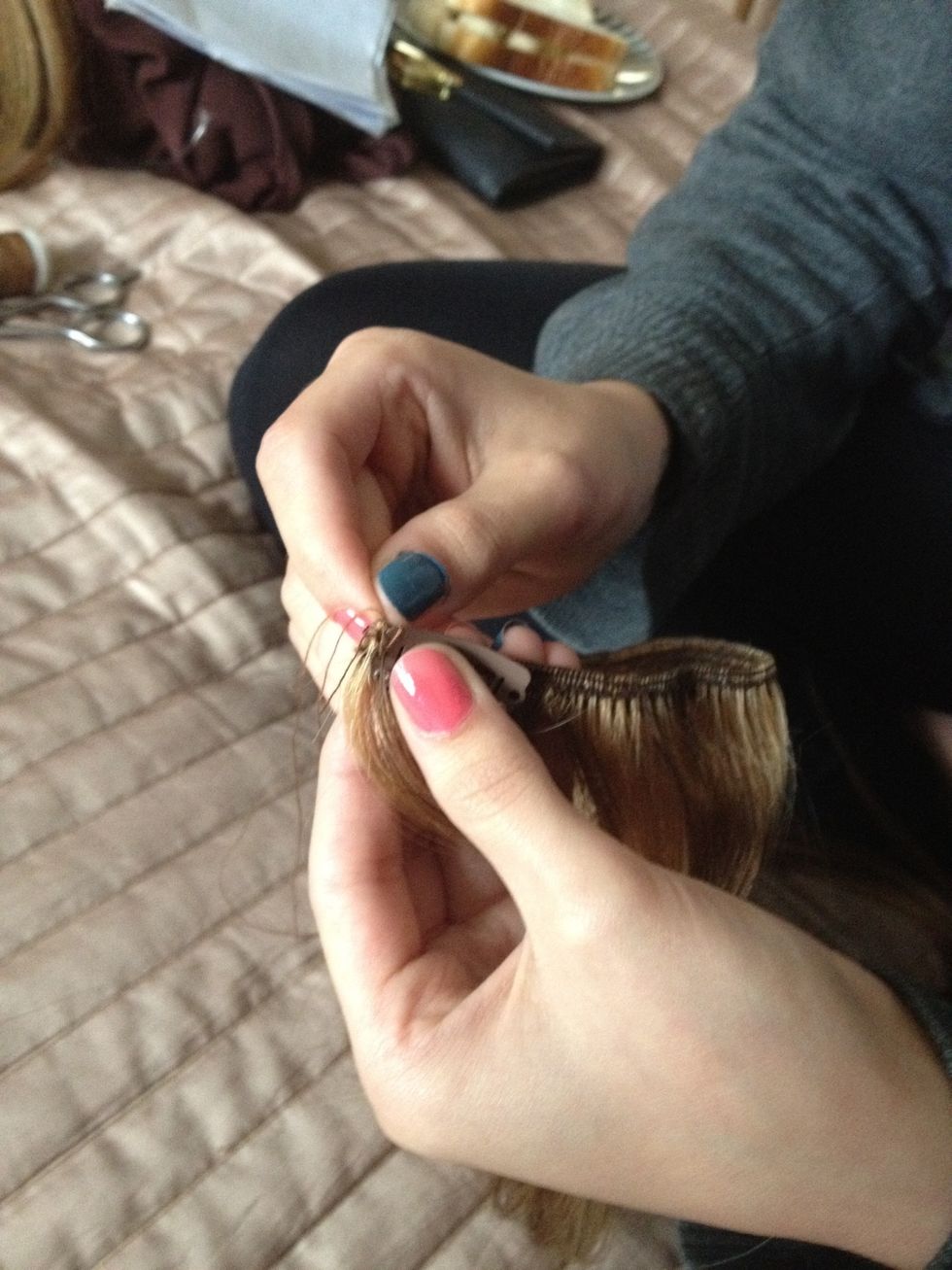 Put the needle through the first hole in the clip like this