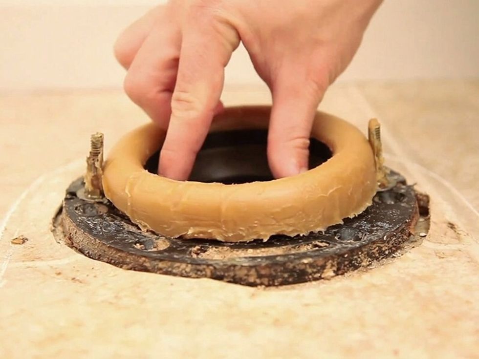 Put the new wax ring in place. Then line the bolts up with the new toilet's bolt holes. To create a secure connection with the wax ring and toilet, place gentle-to-moderate pressure on the toilet.