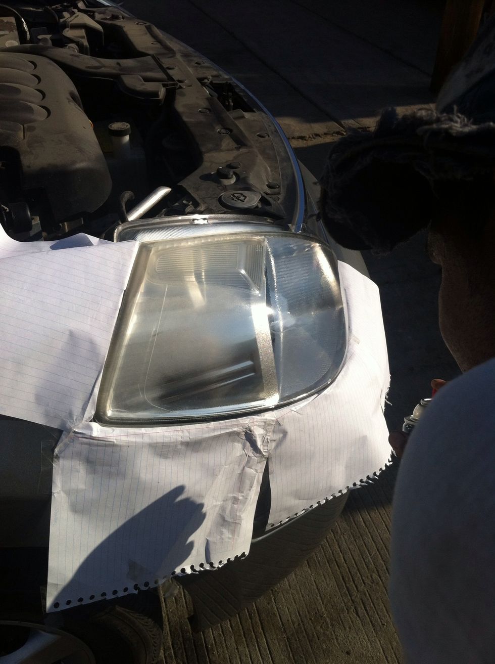 Put the newspaper around your headlights, so the rest of your car won't get sprayed