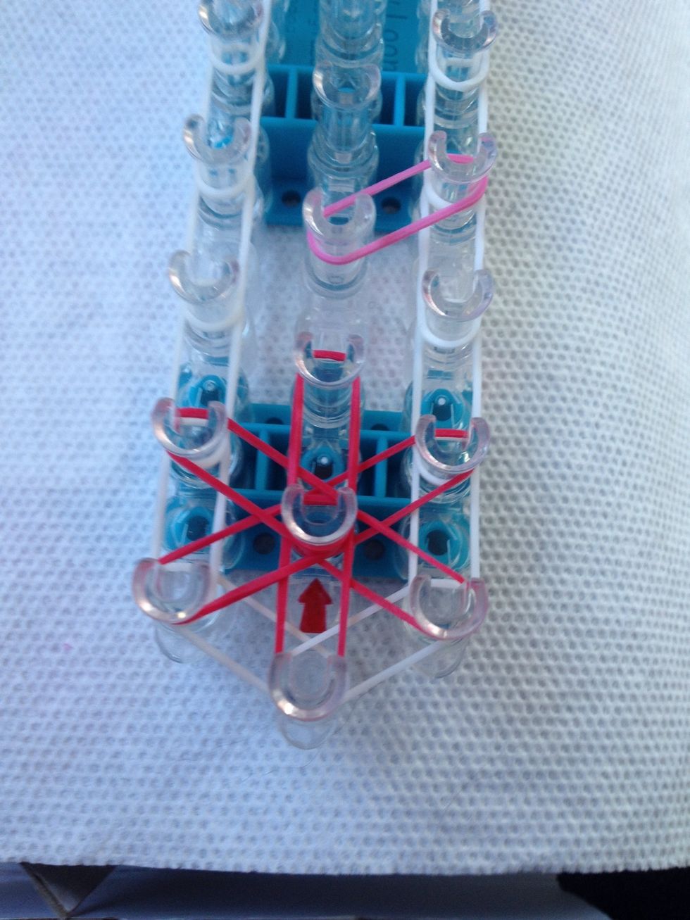 Put the next rubber band color like so. And follow the pattern like the first.