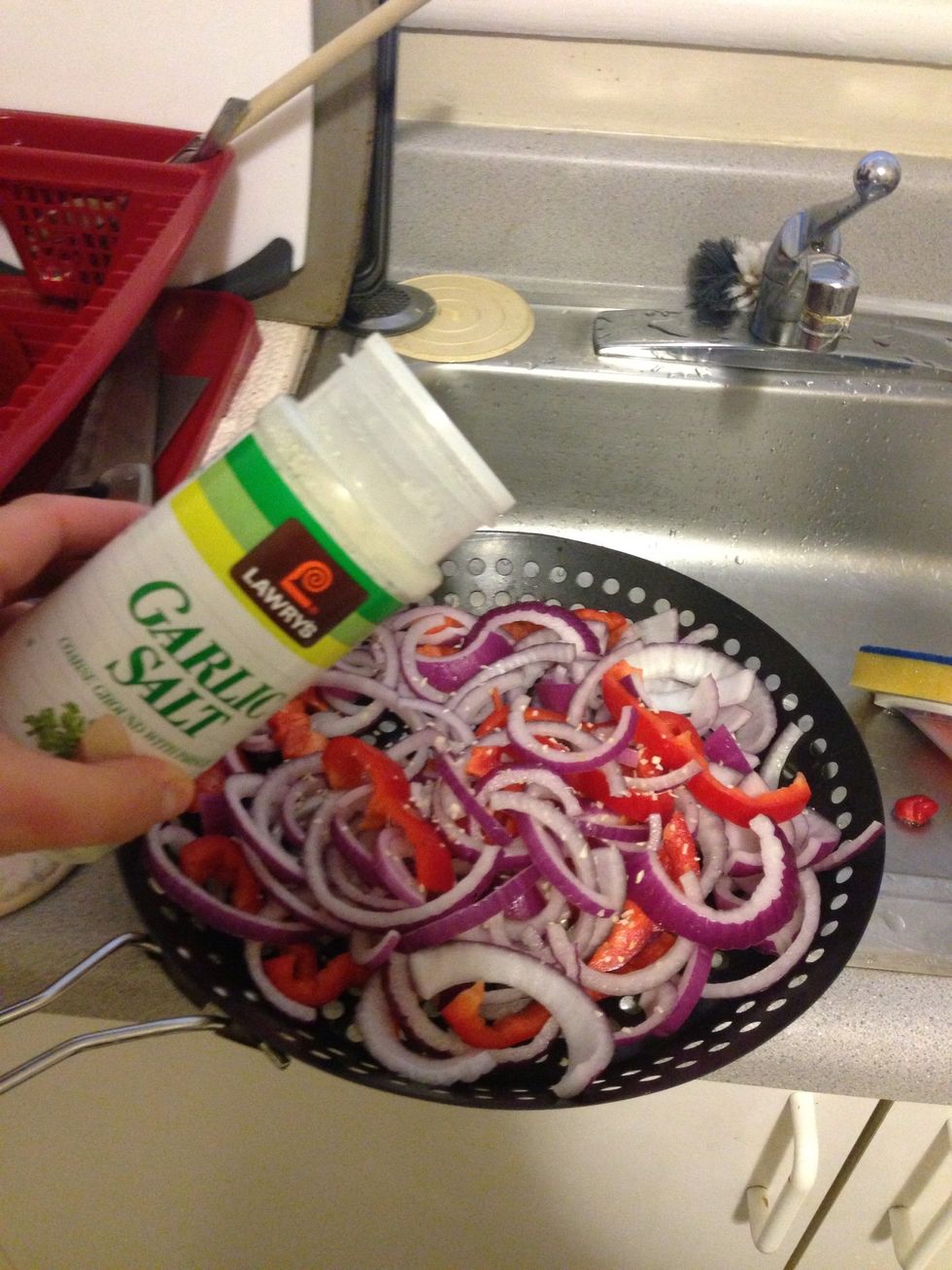 Put the onion mixture in a BBQ safe pan. I sprinkled a pinch of garlic salt on top. This pan is specifically for grilling, but you could use a pan you would normally use in the oven.
