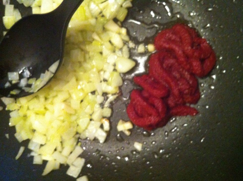 Put the onions in one side of your pan and add tomato paste. If needed some more oil so the paste can be fried properly. It is important to fry the tomato paste so the flavors can come out.
