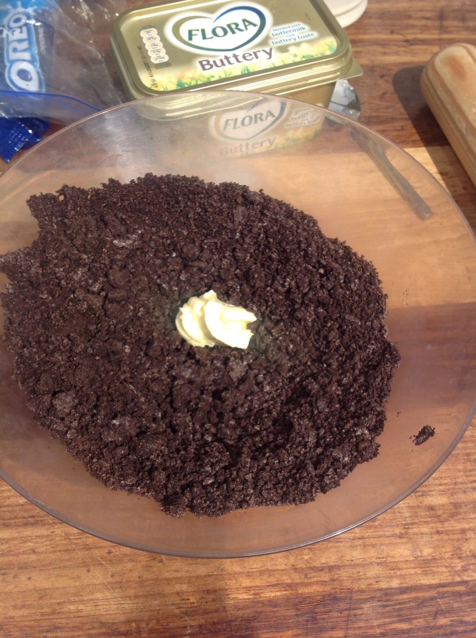 Put the Oreo crumbs in a bowl. Add butter and mix.