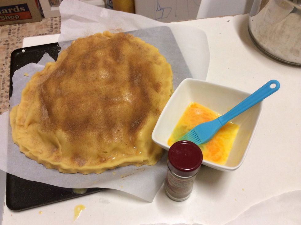 Put the other circle of pastry on the top of the pie. Brush the top of the pastry with 1 lightly beaten egg. Sprinkle cinnamon-sugar on the top of the pie.