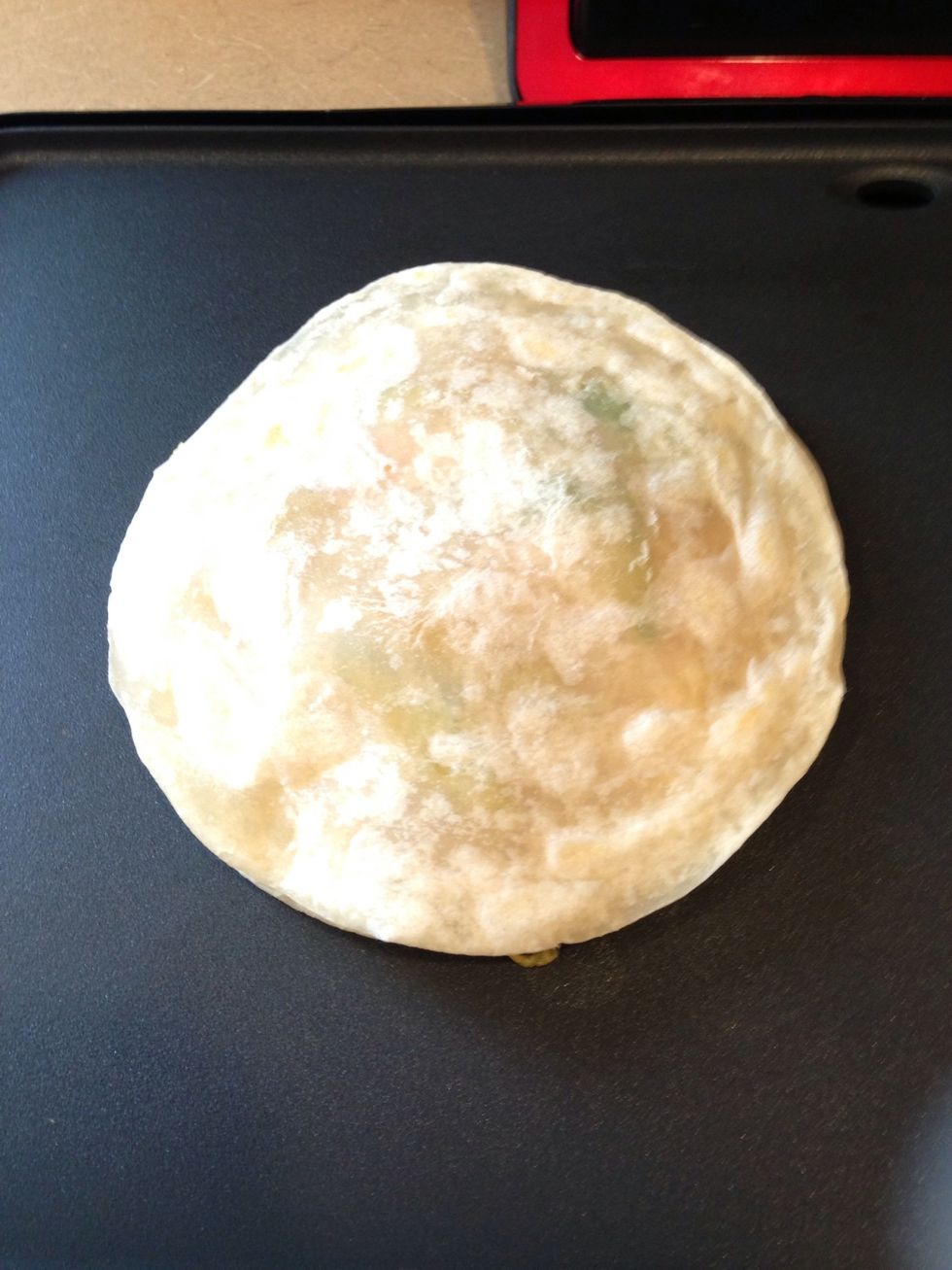 Put the other more browned tortilla side on top facing the inside and put on griddle. Keep it at 300 degrees.