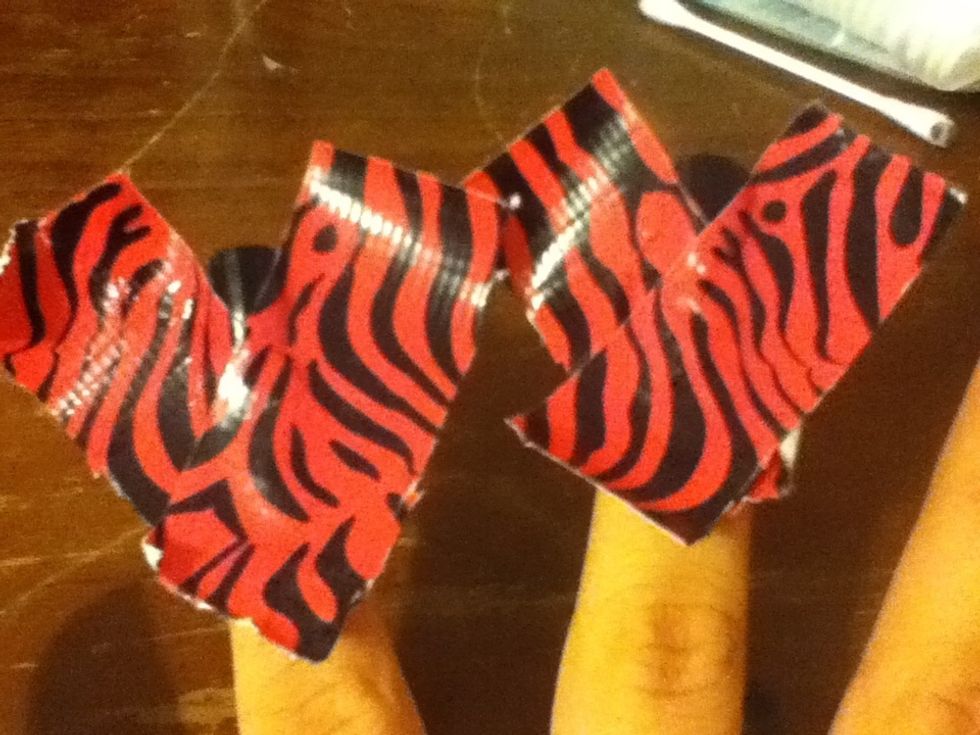 Put the other piece of tape on starting on the right side and ending on the left side. Repeat the process on your other accent nail.