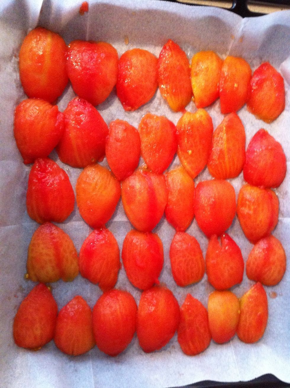 Put the oven on 100 Celsius degree. On a baking pan put baking paper and then put tomato fillet inside out