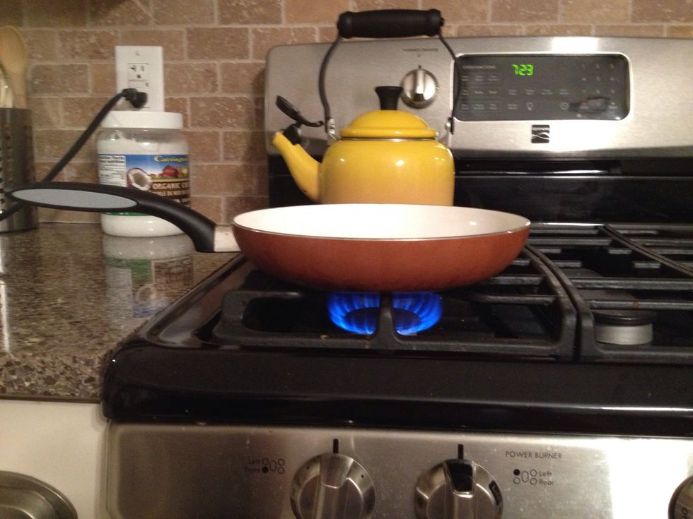 Put the pan on the stove and turn the stove on