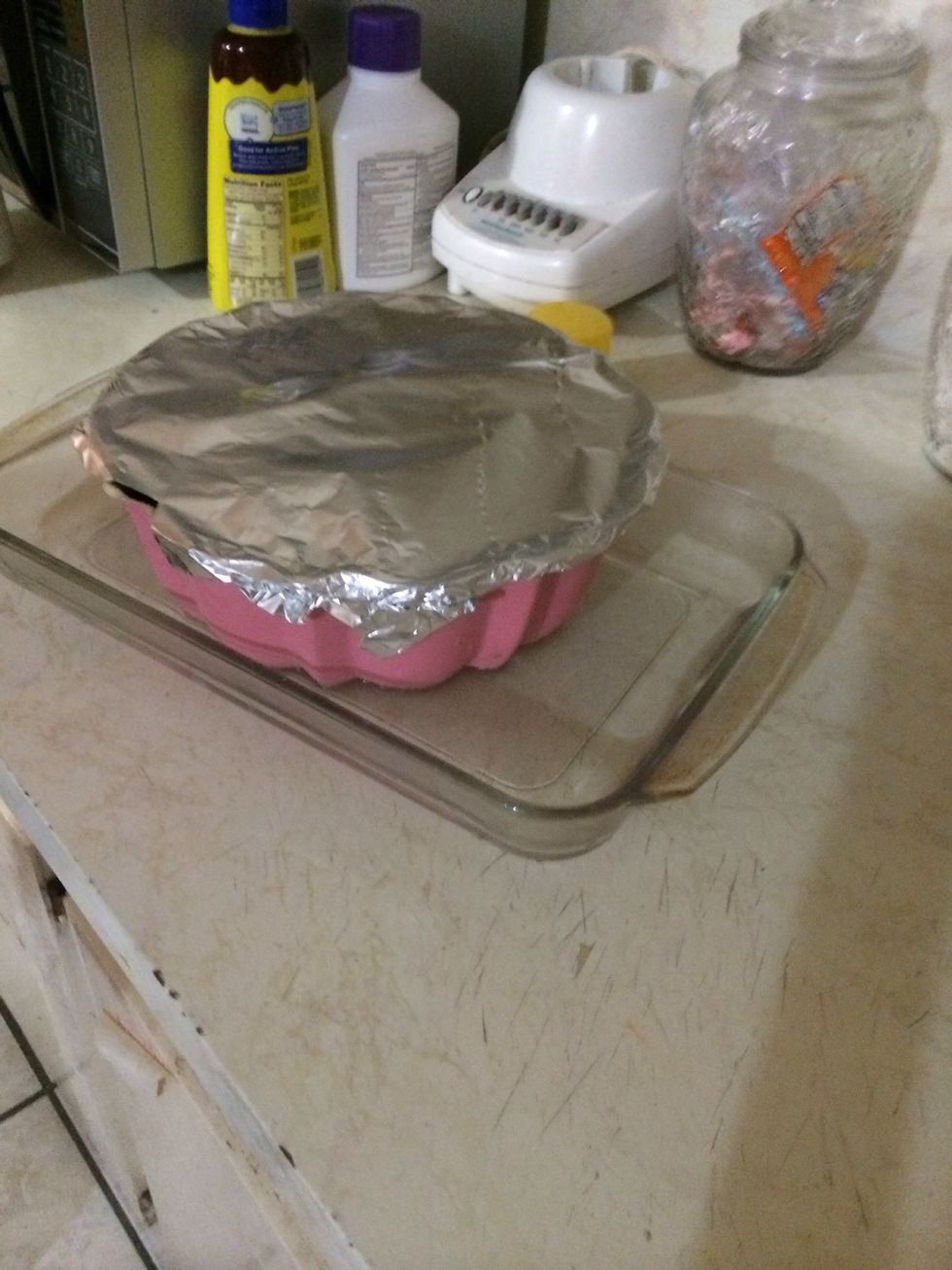 Put the pan with the cake batter into the pan with water