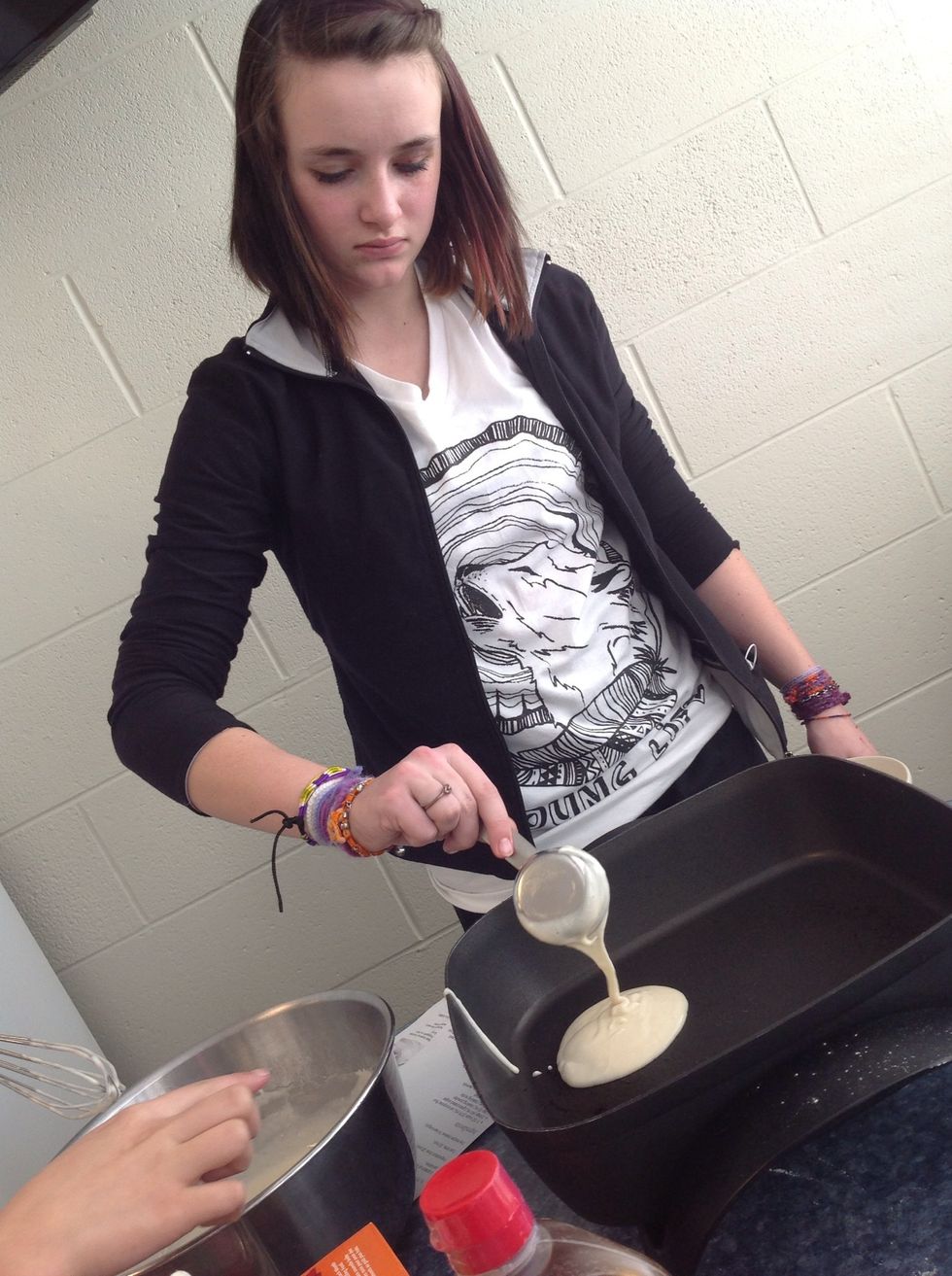 put the pancake mix into the little bowl and put them into the burner and keep them on it until they are light brown on the front and back.