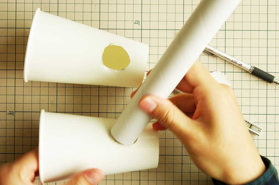 Put the paper tube into the hole.