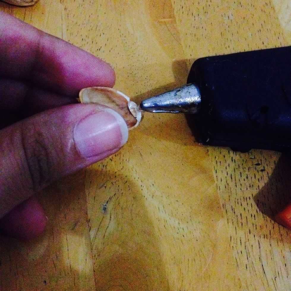 Put the paste on the pistachio's pill.