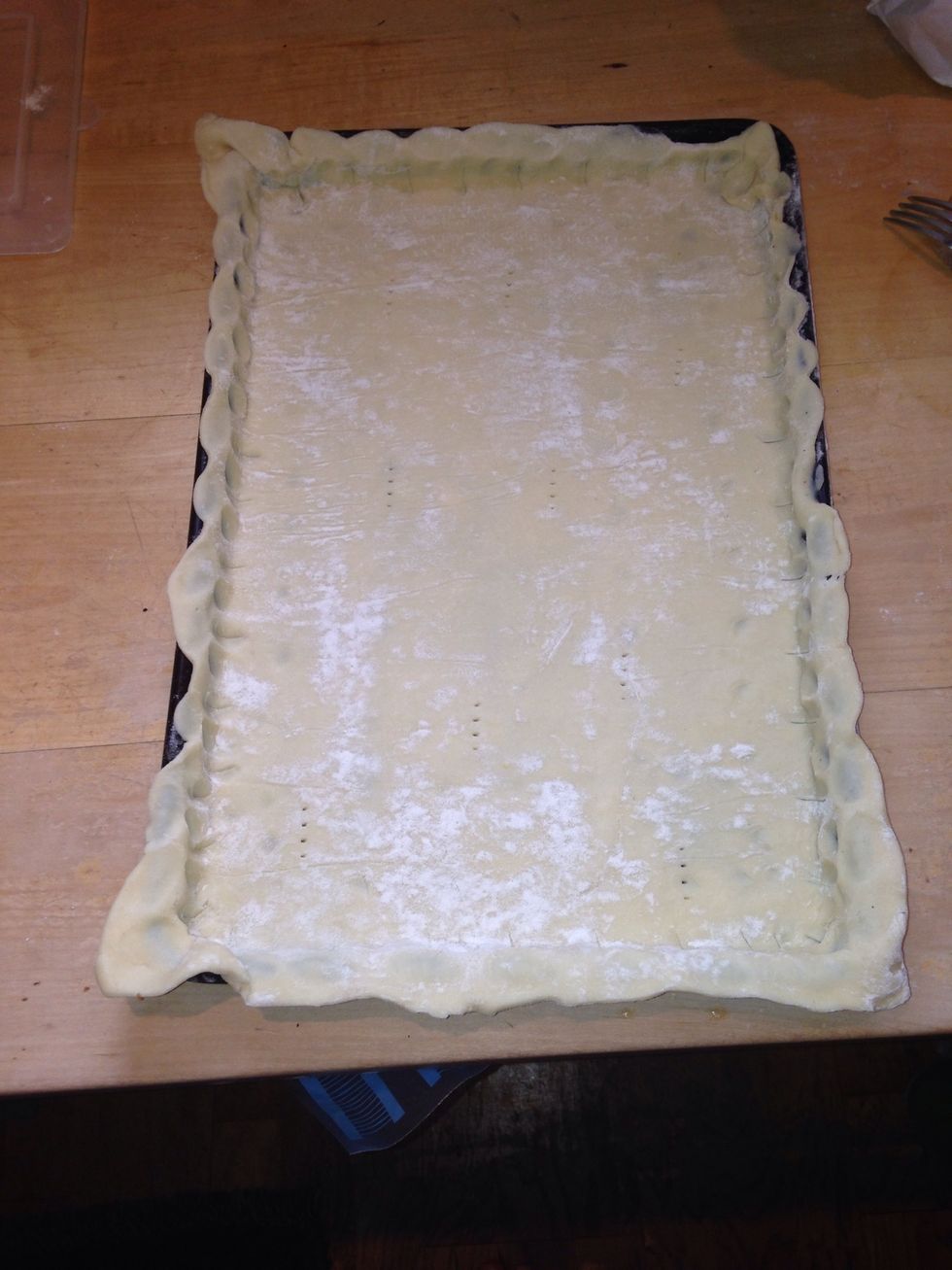 Put the pastry in very well buttered baking tray, pinch the edges and prick a few times with a fork