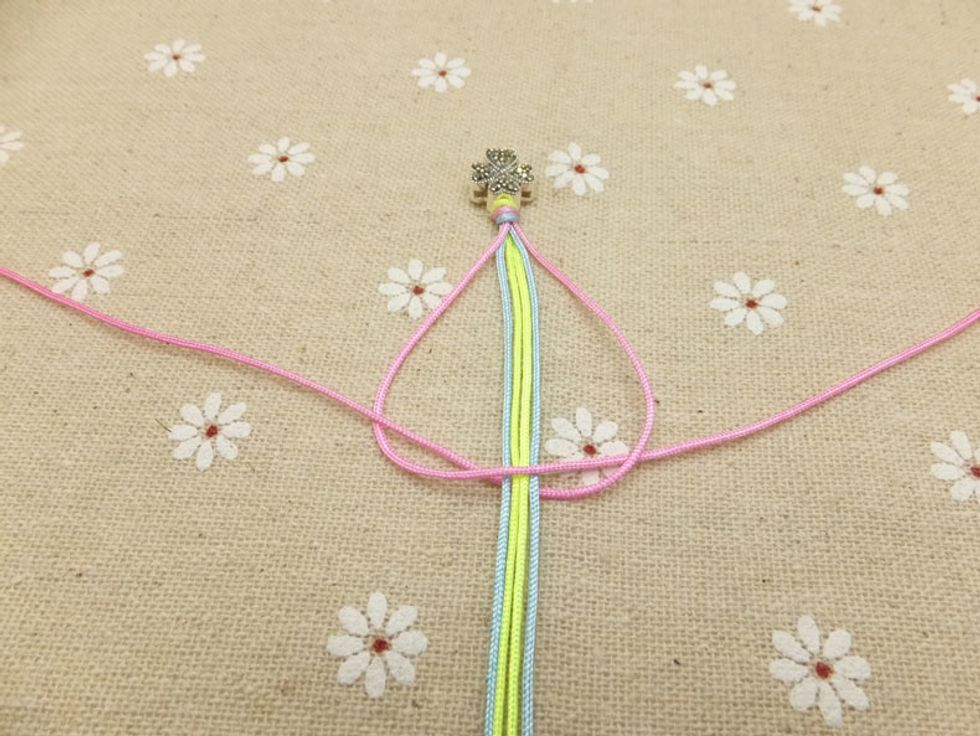 Put the peach cord on the right over the other peach cord from the left and under the holding cords. And then take it out from left loop on the left. The braiding method above is called square knot.