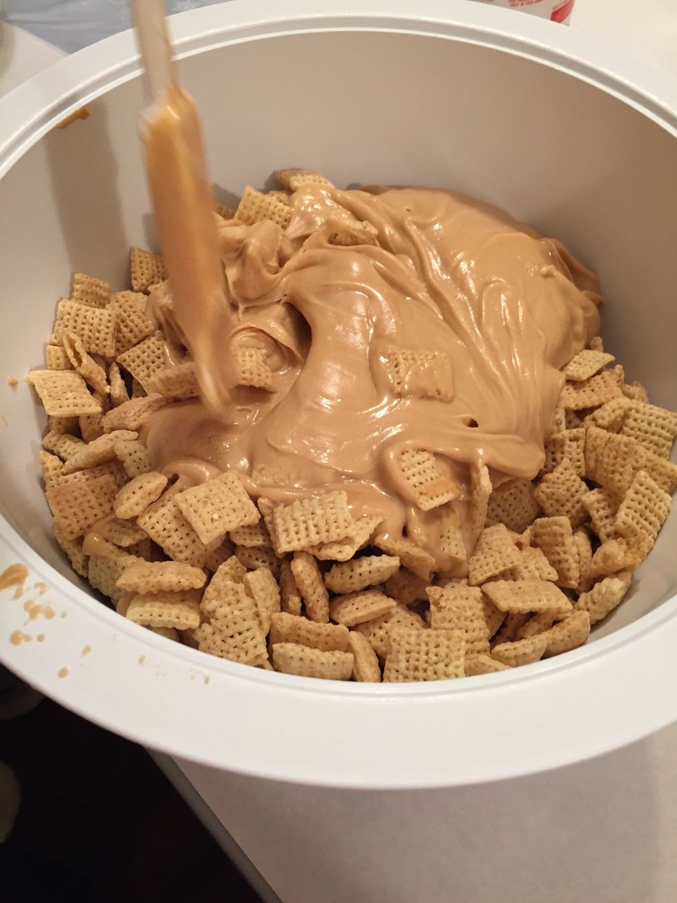 Put the peanut butter mix into the bowl of chex and stir until fully coated.