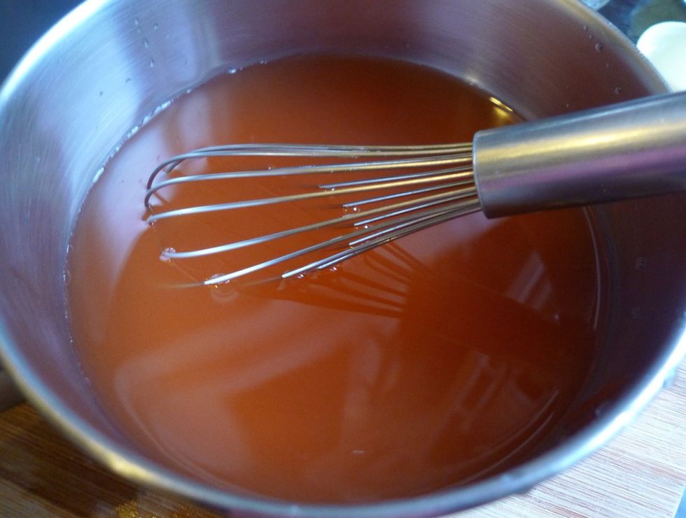Put the pineapple juice, vinegar and tomato ketchup in a saucepan. Whisk all the ingredients together.
