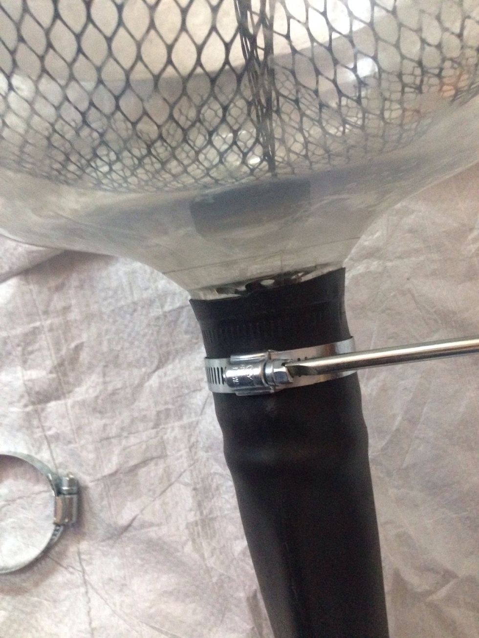 Put the pipe into the bottle and tie a ring from the top