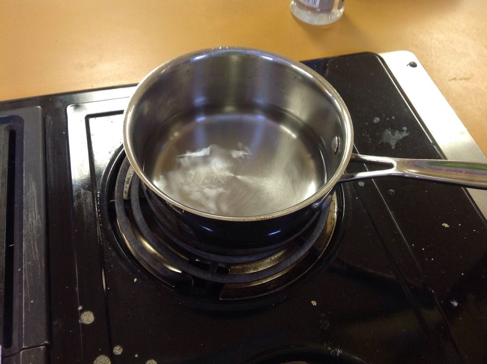 Put the pot of water on the burner.