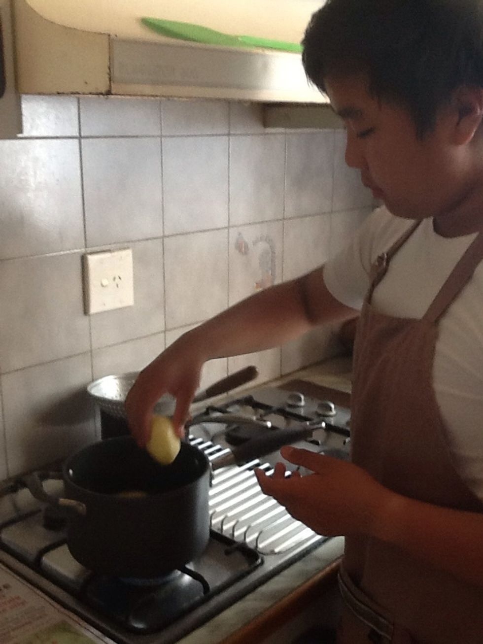 Put the potatoes in a pot to boil until it softens for mashing on later.