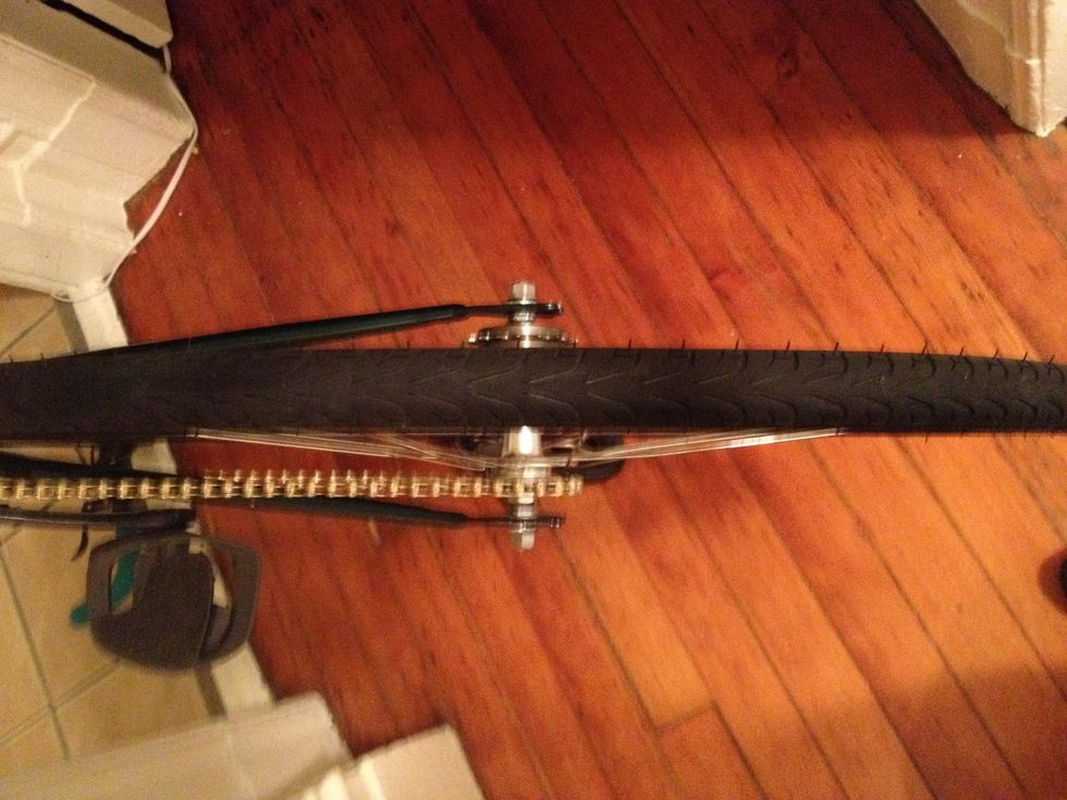 Put the rear wheel back on, this time so that the new cog lines up with the chain.