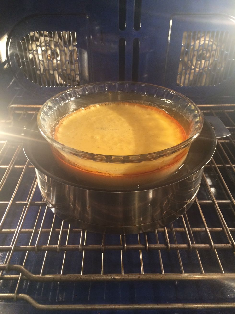 Put the recipient in a water bath. Bake in a preheated oven 130-140C for 1:30 hr or untill a knife inserted in the middle comes out clean.