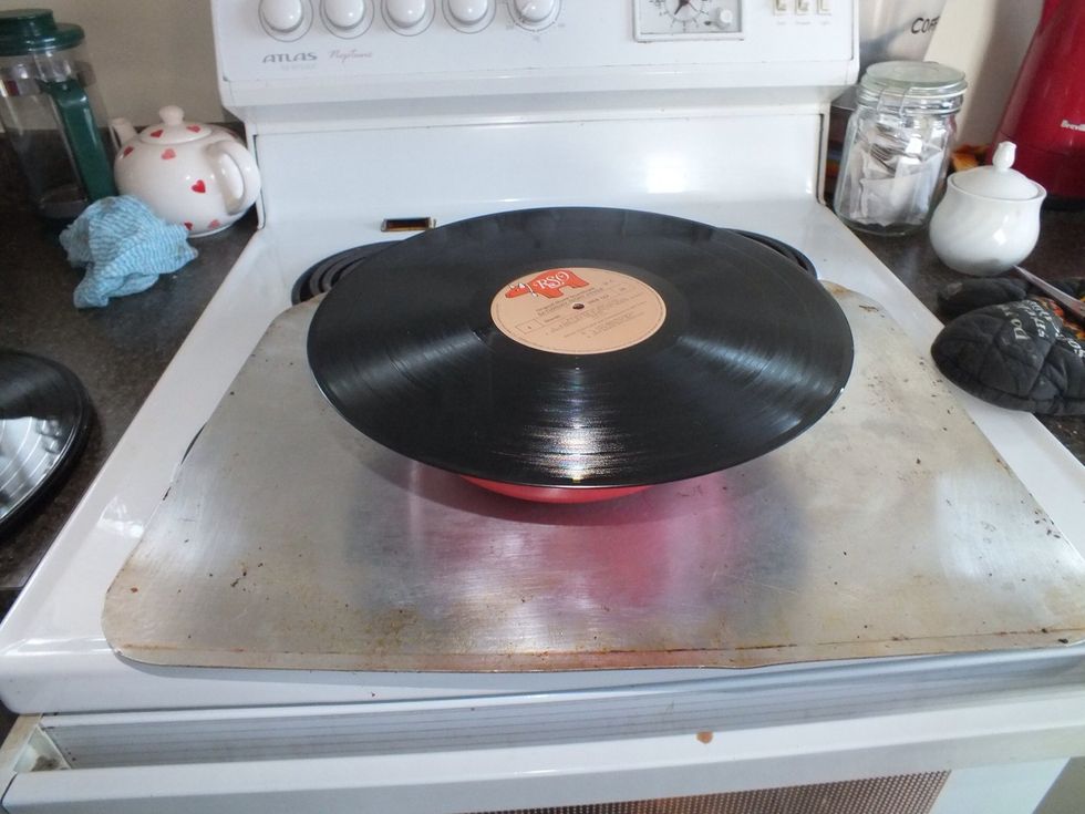 Put the record on top of the oven proof dish. Preheat oven to 100c.