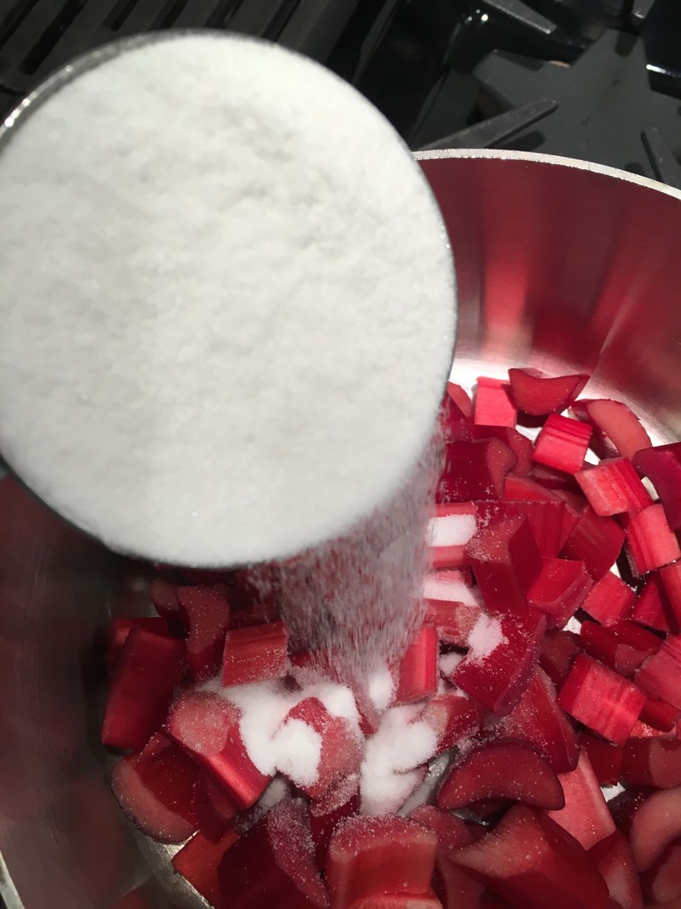 Put the rhubarb in a saucepan and add the sugar. Turn the stove on to low.