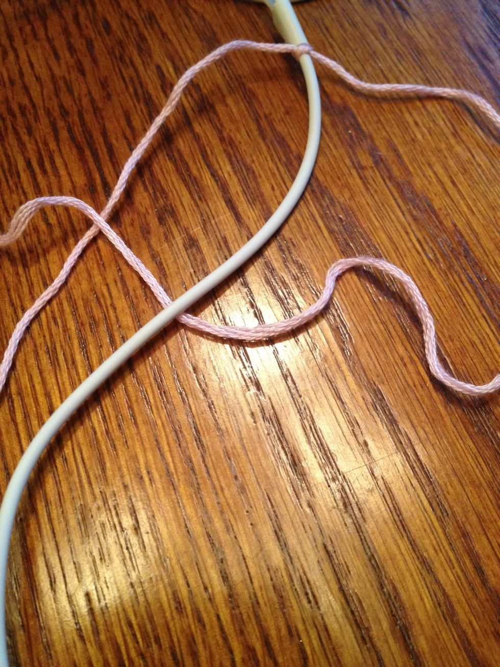 Put the right string underneath the cord and over top the left string