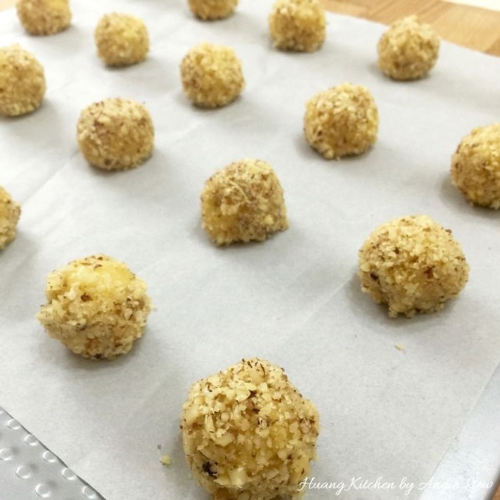Put the rolled ball on the lined baking sheet. Continue to do the same for the rest of the dough balls. Evenly space them on the baking sheet.
