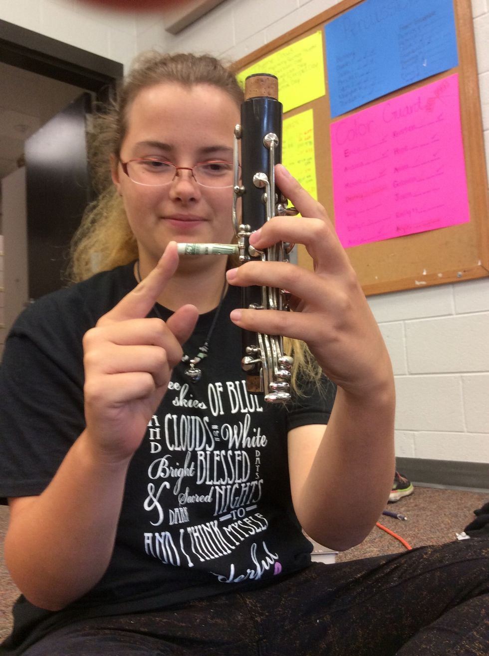 Put the rolled dollar bill in the clarinet hole so you can clean the inside.