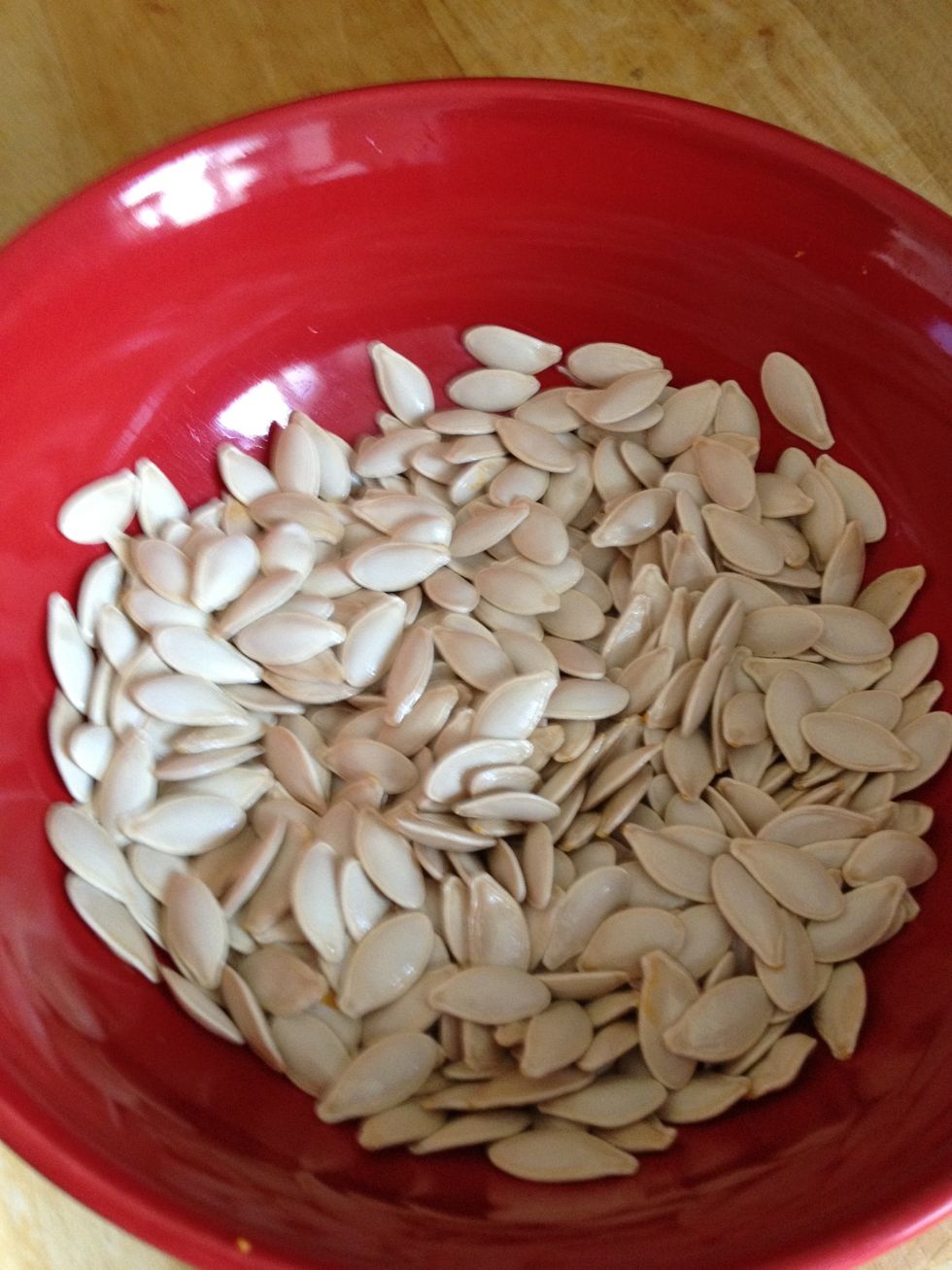 Put the seeds into the bowl and add a little oil.