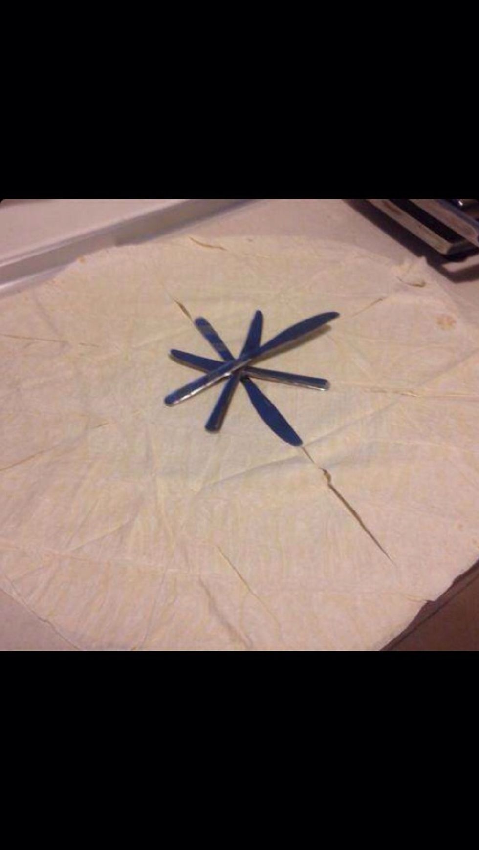 Put the sheets on top of each other and carefully slice into pizza style slices. My borek sheets are really large so I'm slicing 8 pieces per sheet. If yours are smaller, try slicing 4 or 6 instead.