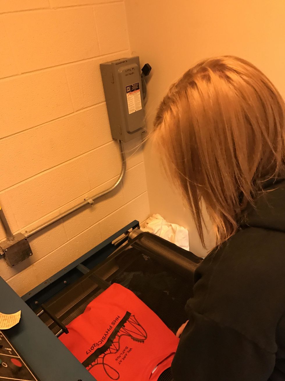 Put the shirt on the conveyor belt making sure the design is not touching any other part of the shirt.