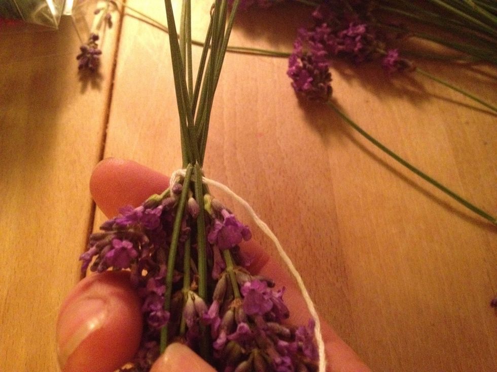 Put the short end of the string in side the lavender bouquet and turn your small bouquet up side down. Fold 2 stems down over the long end of your string.