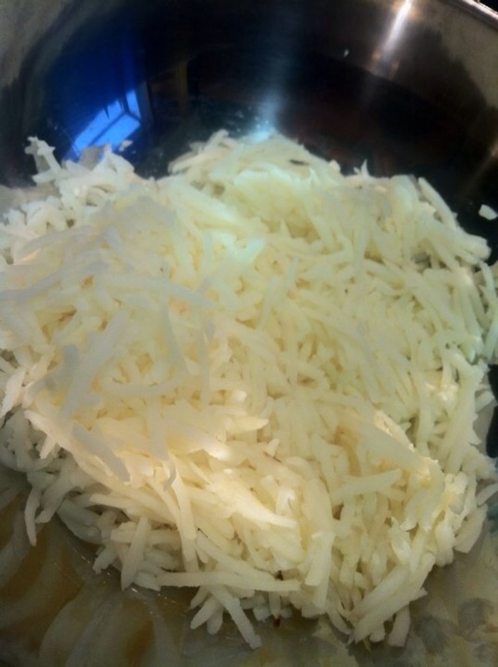 Put the shredded potatoes in a large mixing bowl and pour over a stick of melted butter and toss thoroughly.  (For a lower fat version of this dish eat carrots.)