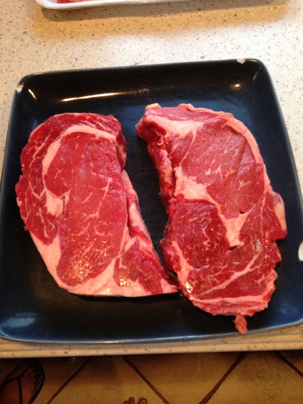 Put the steaks on a plate to season them